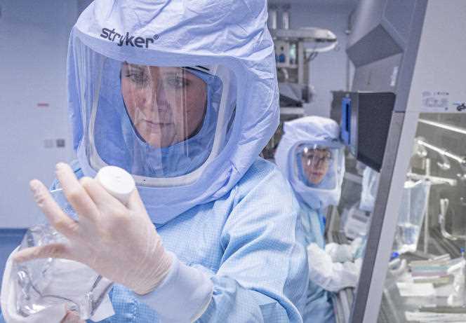 Dressed in full protective suits, laboratory assistants from Biontech company simulate the final stages of Corona vaccine production on a bioreactor in a clean room at the new production site in Marburg, Germany on March 30, 2021.