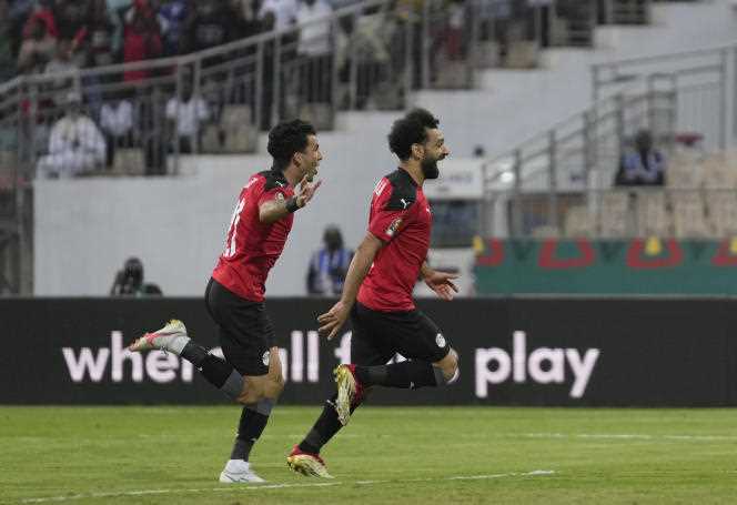 Mohamed Salah, center, and Ahmed Sayed Zizo celebrate after team-mate Mahmoud Hassan Trezeguet scored a second goal, during the 2022 Africa Cup of Nations quarter-final match between Egypt and Morocco at the Ahmadou- Ahidjo, in Yaoundé (Cameroon), Sunday January 30, 2022.