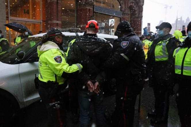 Police arrest a protester during a mobilization against health measures and the government of Justin Trudeau, in Ottawa, February 17, 2022.