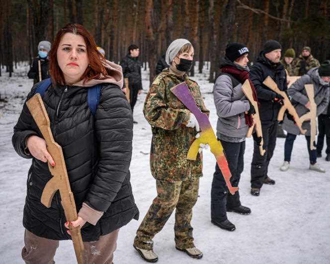 Ukrainian civilians use dummy weapons during military training in the Dniprovskii dormitory district of Kiev on February 5, 2022.