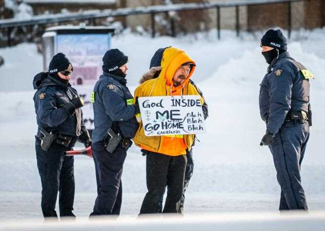 A protester is arrested by police in Ottawa on February 18, 2022.
