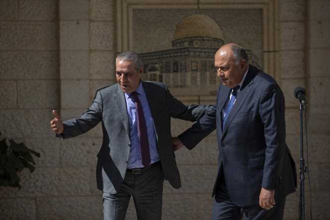 Israel Relations Minister Hussein Al-Sheikh (L) stands with Egyptian Foreign Minister Sameh Shoukry after a meeting with Palestinian President Mahmoud Abbas, in Ramallah, West Bank, May 24, 2021.