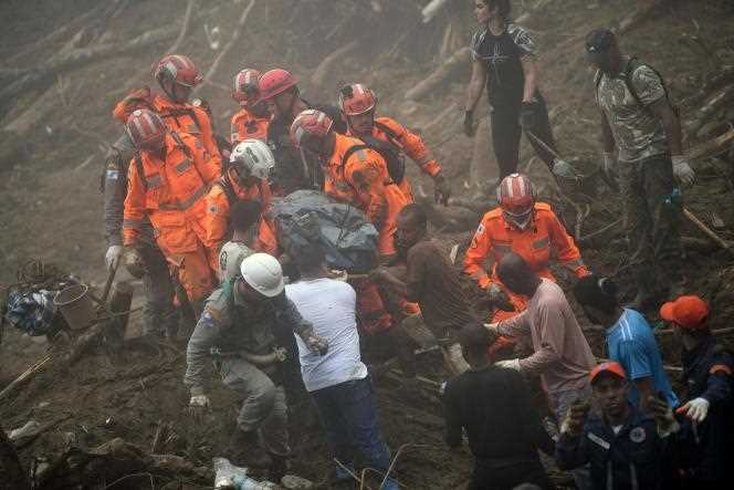 Rescuers pull out the body of a victim of a mudslide in Petropolis, Brazil, February 19, 2022.