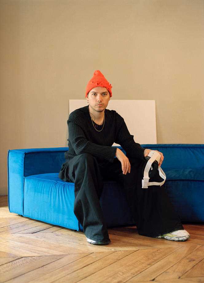 Harry Nuriev, at his home in Paris, January 22, 2022. He is seated on a Crosby Café velvet sofa, made by Crosby Studios.
