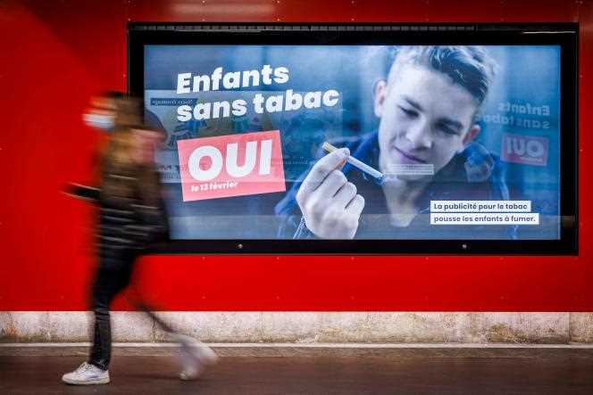 An election poster advocating a ban on tobacco advertising, in Lausanne, Switzerland, February 8, 2022
