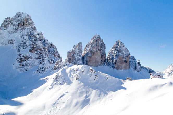 The Cima Piccola (2,856 m), the Cima Grande (2,998 m) and the Cima Ovest (2,973 m) which make up the Tre Cime di Lavaredo, with the Locatelli refuge at their feet.