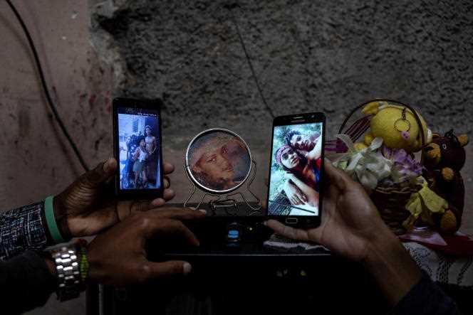 Relatives show photos of the three Roman siblings who are jailed for taking part in anti-government protests, Wednesday, January 19, 2022.