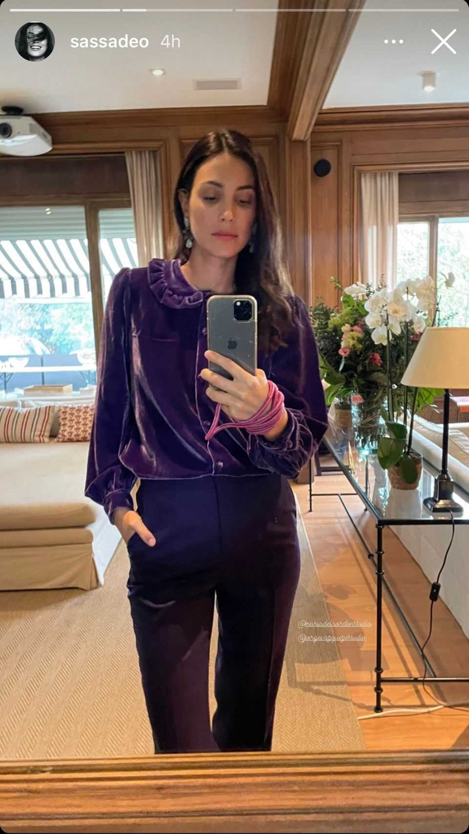 Alessandra de Osma poses in front of a mirror in her home