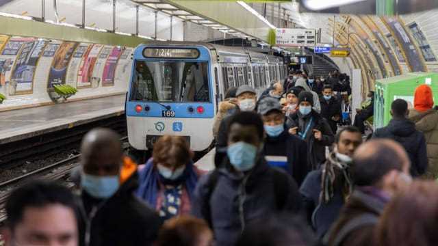 People on the Paris Metro wear masks.