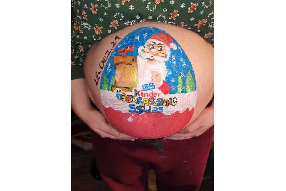 Paint the baby bump: Kinder Surprise egg painted on the baby bump
