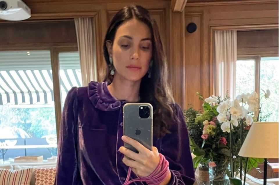 Alessandra de Osma poses in front of a mirror in her home