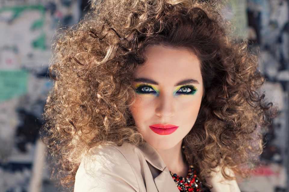 New looks from the old days: Woman with curly hair wears heavy make-up