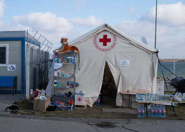 A Romanian Red Cross tent, as close as possible to the landing area for barges crossing the Danube from the Ukrainian side, in Issacea (Romania), March 11, 2022. The volunteers stored basic necessities: water , medicine, food and toys for newly arrived refugees.