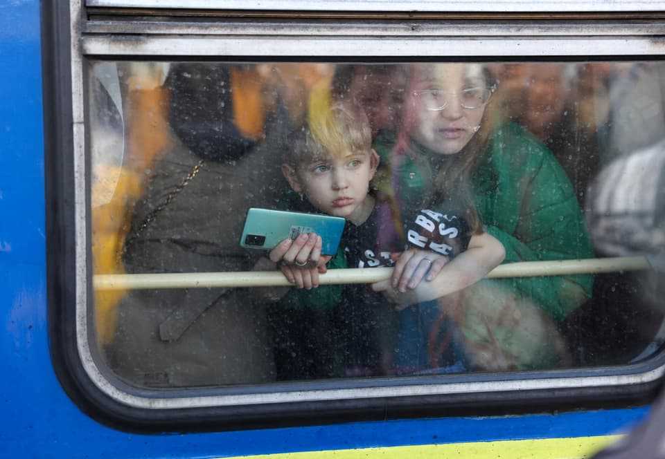 A woman and her son disembark an evacuation train from Kyiv to Lviv at Kyiv Central Station on February 25.