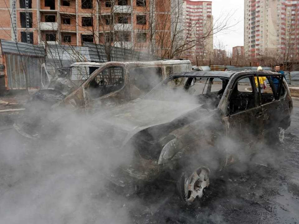 Charred cars in the separatist-held city of Donetsk after shelling.