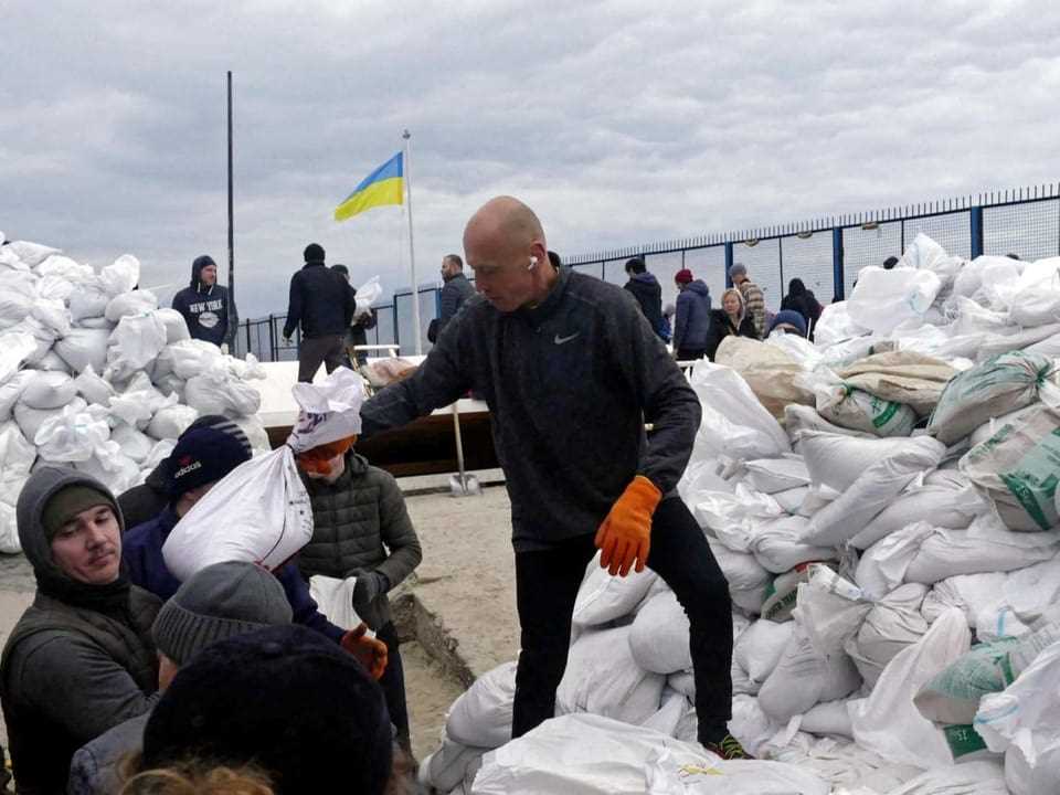 Volunteers fill sandbags in Odessa to set up barricades