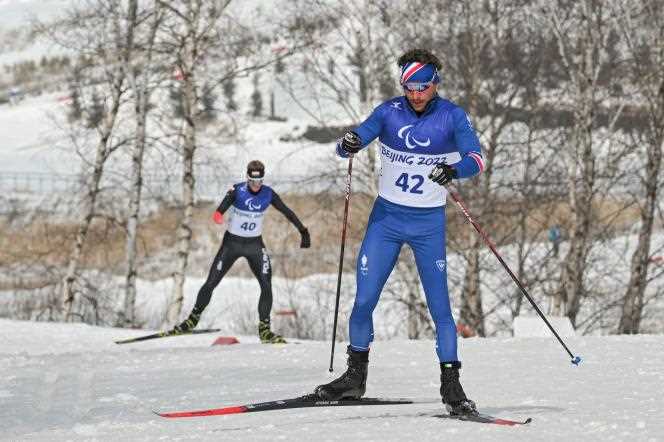 Frenchman Benjamin Daviet (right) during the men's cross-country skiing middle distance event (standing category) on Saturday March 12, 2022, at the Zhangjiakou National Biathlon Center, during the Beijing 2022 Paralympic Winter Games.