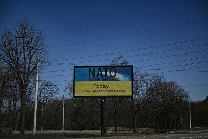 'NATO closes the skies today,' reads a billboard, during a 36-hour curfew in Kyiv on March 22, 2022.