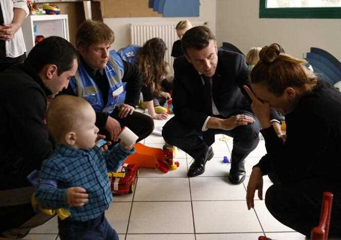 French President Emmanuel Macron visiting a reception center housing Ukrainian refugees on March 15, 2022, in La Pommeray, Maine-et-Loire.