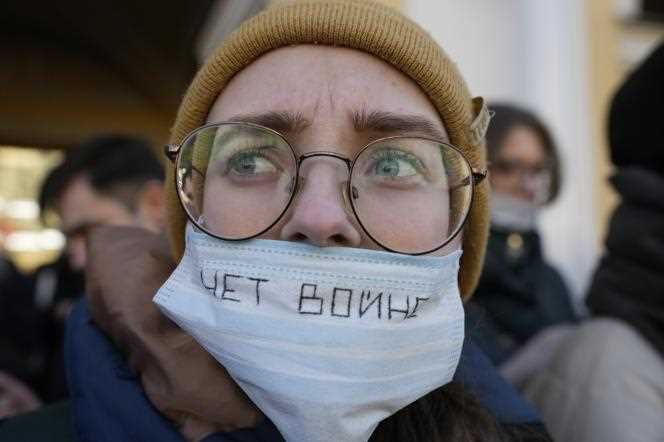 A protester with a mask reading 