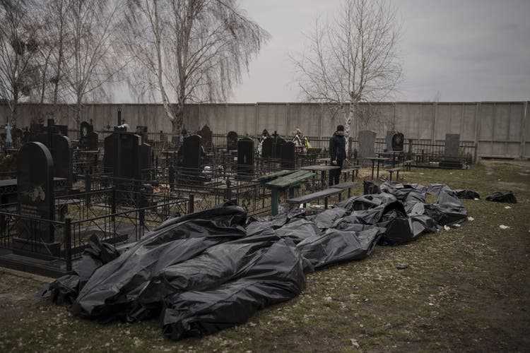 Bodies of murdered civilians packed in sacks at a cemetery in Bucha.
