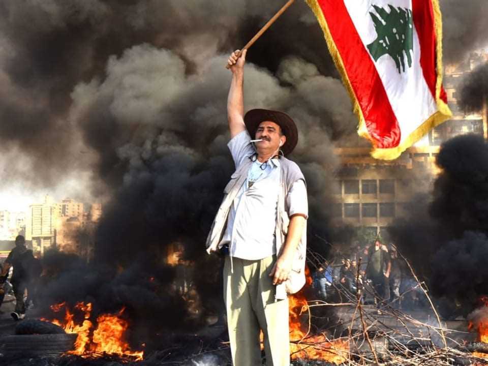 Man waving Lebanese flag