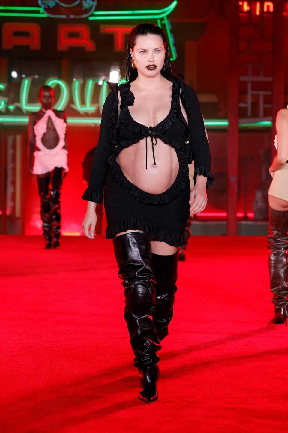 Adriana Lima shows up with a baby ball on the Alexander Wang catwalk. 