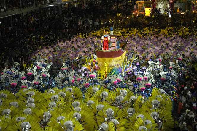 Artists from the Sao Clemente samba school parade on a float during the Rio carnival, April 23, 2022.