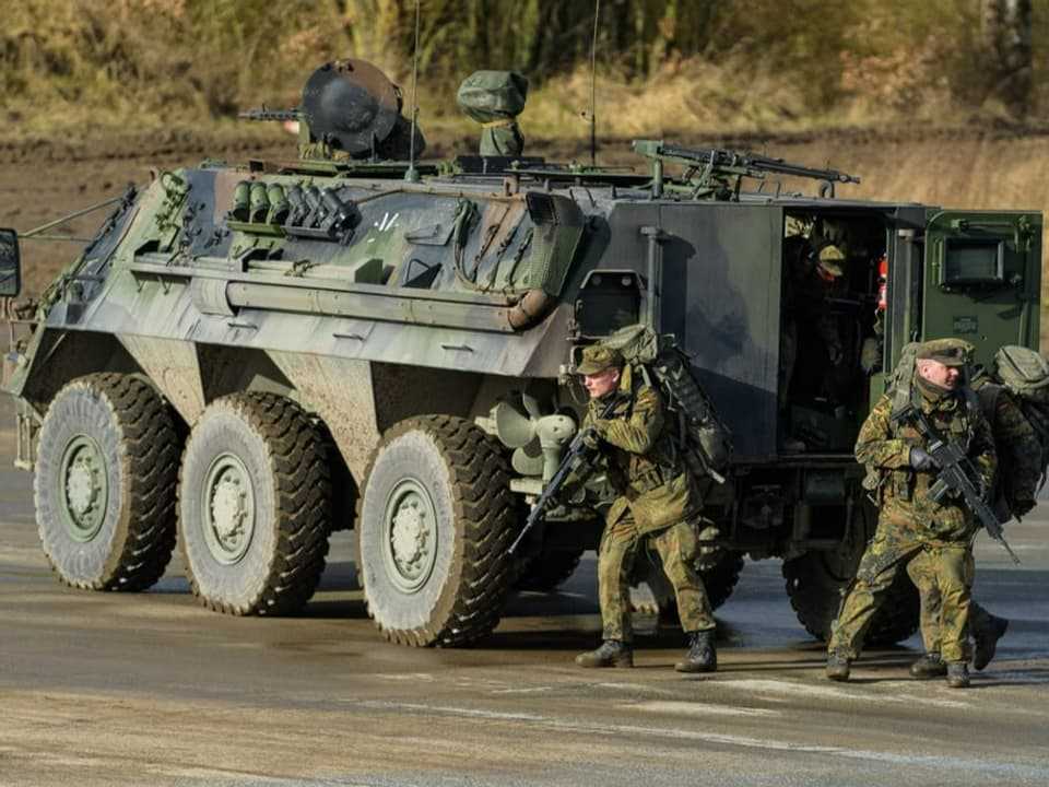 A Fuchs-type wheeled tank of the Bundeswehr is on the training ground during a combat demonstration. 