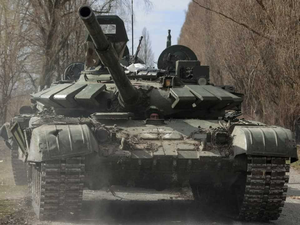 A Ukrainian soldier drives a captured Russian T-72 tank in Lukianivka in March 2022. 