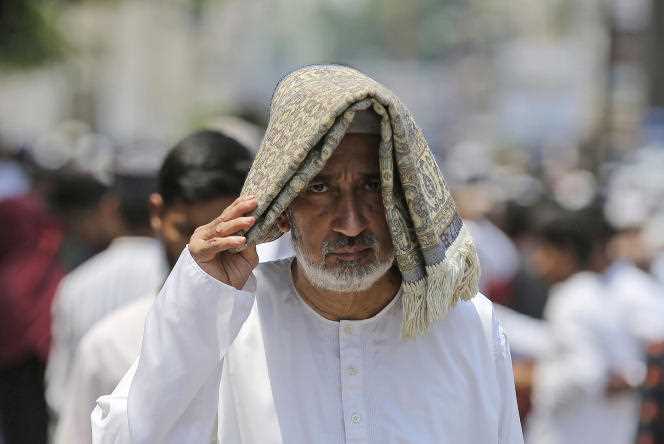 A man shields himself from the sun and sweltering heat after prayers on the last Friday of Ramadan, April 29, 2022, in Hyderabad.