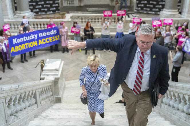 A member of the Kentucky House of Representatives walks past an abortion rights protest at the State Capitol in Frankfort on April 13, 2022.