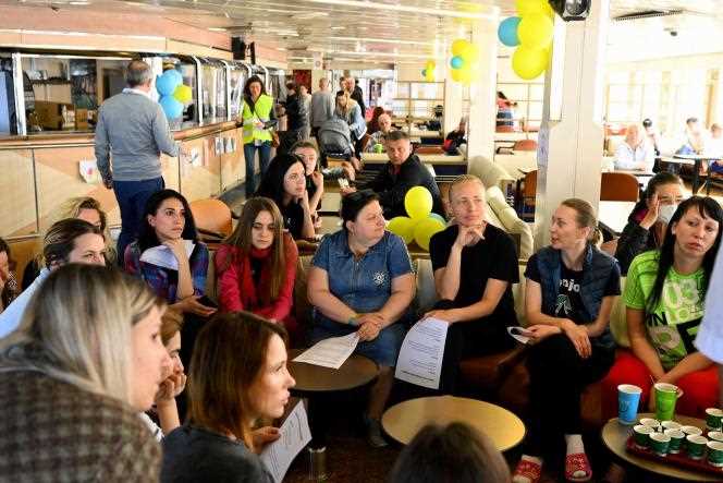 Ukrainian women take part in a meeting to find a job in France on board the 