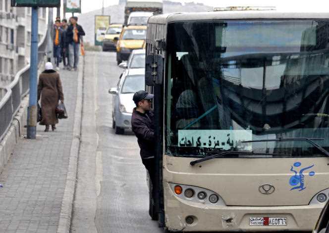 A man boards a bus in the Old City district of Damascus on February 1, 2022. 