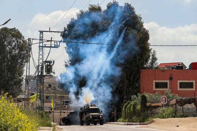 Tear gas is fired from an Israeli military vehicle near the Jenin Palestinian refugee camp in the West Bank on April 9, 2022. 