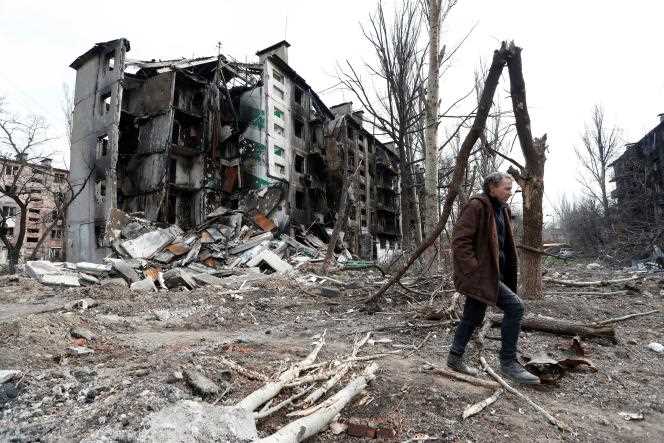 A man walks through the ruins of destroyed buildings in Mariupol, Ukraine, April 17, 2022.