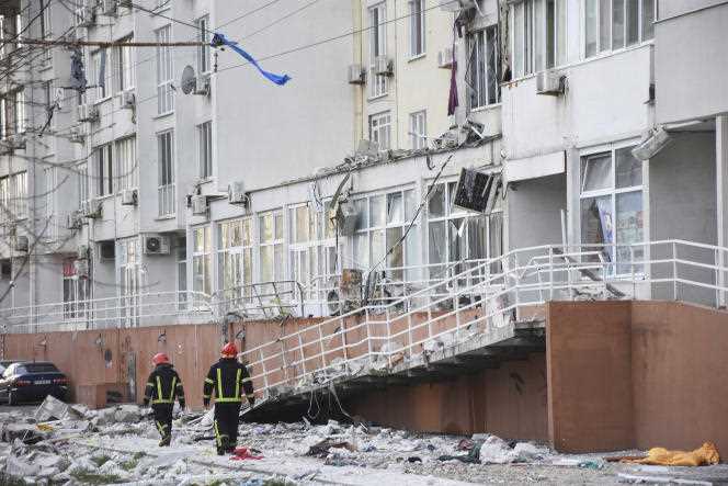 Firefighters in front of a building damaged by a Russian bombardment, in Odessa, Ukraine, April 23, 2022. 