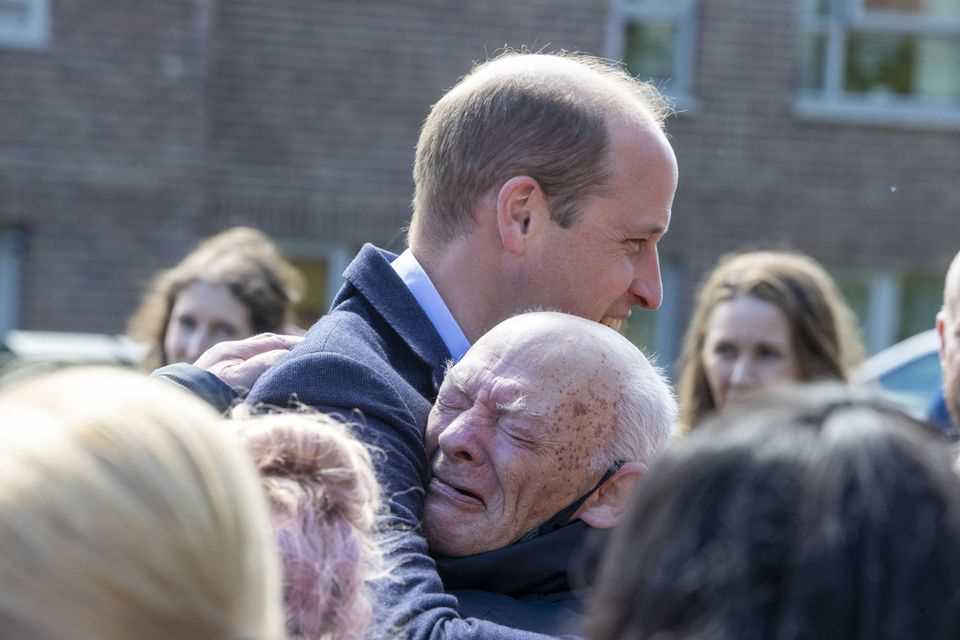 Prince William hugs pensioner William Burns in Glasgow