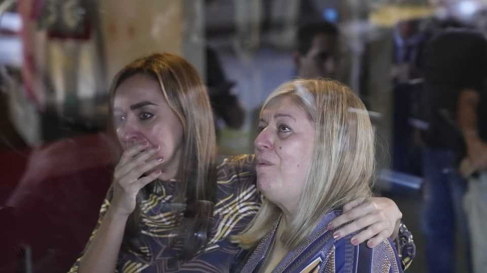 Two women mourn the death of the prosecutor.