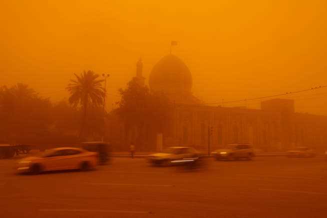 A mosque in Baghdad can hardly be seen from a distance because of the sandstorm.