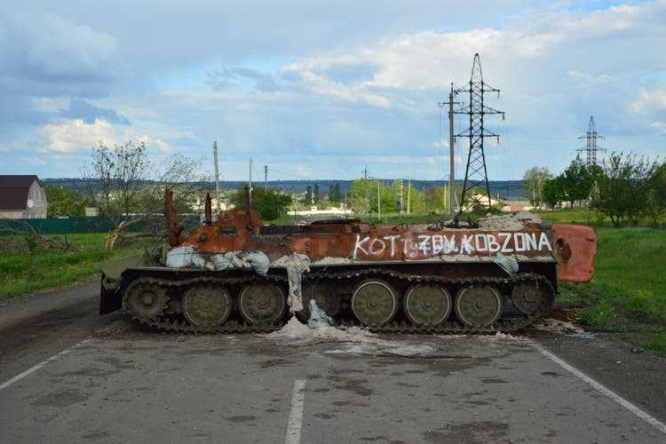 A wrecked Russian military vehicle on a street in Vikhivka.