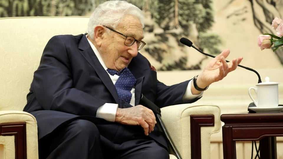 Kissinger in a chair