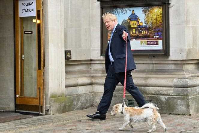 Britain's Prime Minister Boris Johnson arrives with his dog Dilyn outside his polling station, located in Methodist Hall, central London, for local elections on May 5, 2022 in the UK.