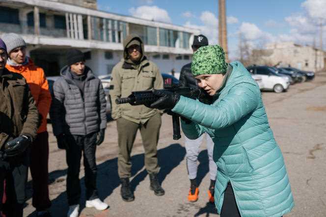 A woman practices shooting with civil defense volunteers in Odessa, Ukraine, in March.