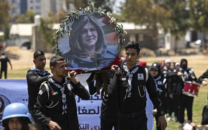 Young Palestinians simulate a funeral procession in honor of journalist Shireen Abu Akleh, on May 17, 2022, in Gaza.