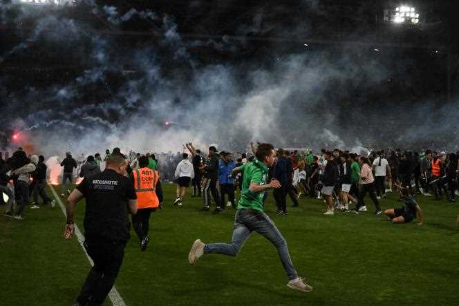 Supporters invade the field at the end of the match between AS Saint-Etienne and AJ Auxerre, at the Geoffroy-Guichard stadium, in Saint-Etienne, on May 29, 2022.