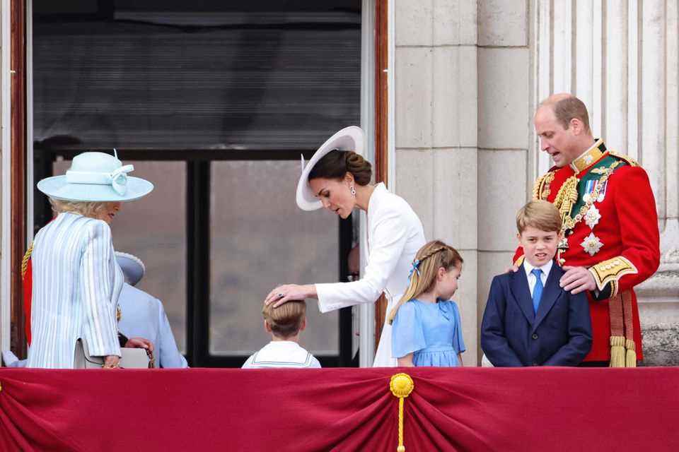 The Royal Family leaves the balcony of Buckingham Palace.  Duchess Catherine lovingly caresses her youngest's head.  Prince Louis fought bravely.