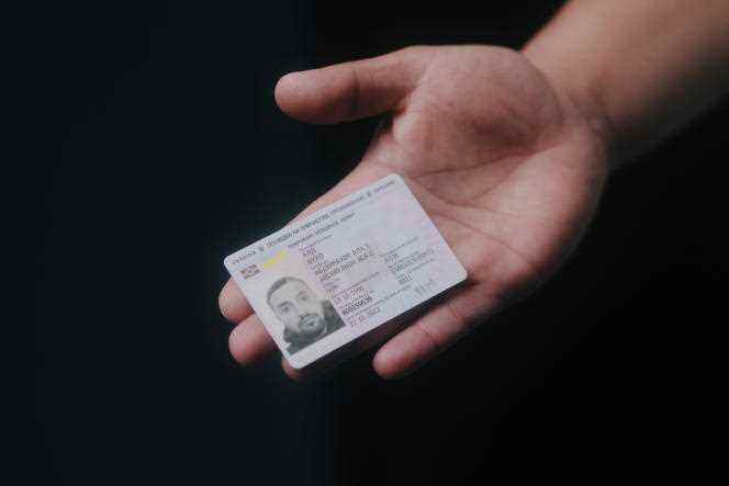 Alaedine Ayad, an Algerian student and refugee from the conflict in Ukraine, shows his Ukrainian resident card, in Paris, June 2, 2022.