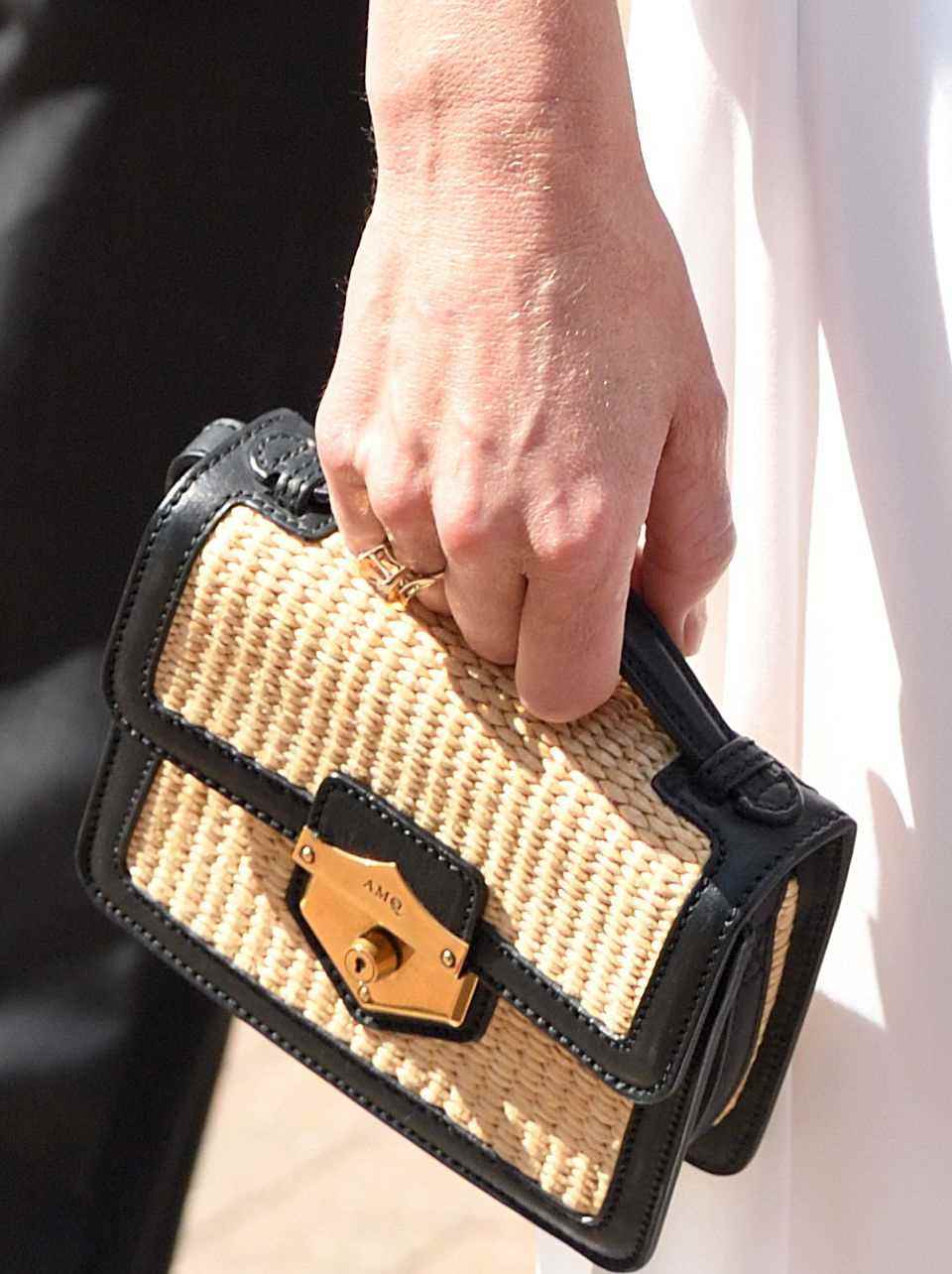 Kate's Alexander McQueen bag captivates with its elegant beach flair. 