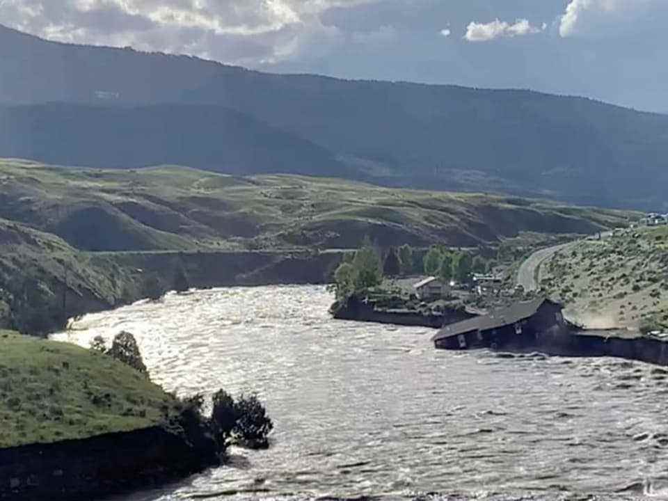A house on the Yellowstone River is swept away by the water.